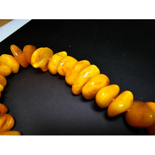 189 - A good quality vintage genuine butterscotch amber beaded necklace featuring polished shaped amber be... 