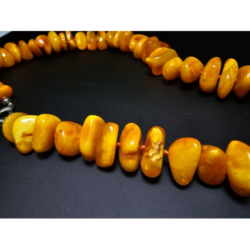 189 - A good quality vintage genuine butterscotch amber beaded necklace featuring polished shaped amber be... 