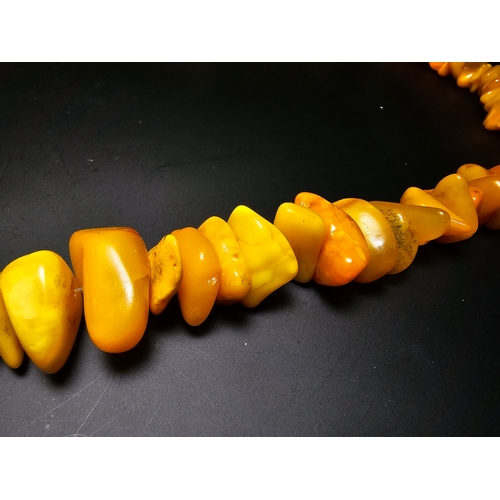 190 - A good quality vintage genuine butterscotch amber beaded necklace featuring polished shaped amber be... 