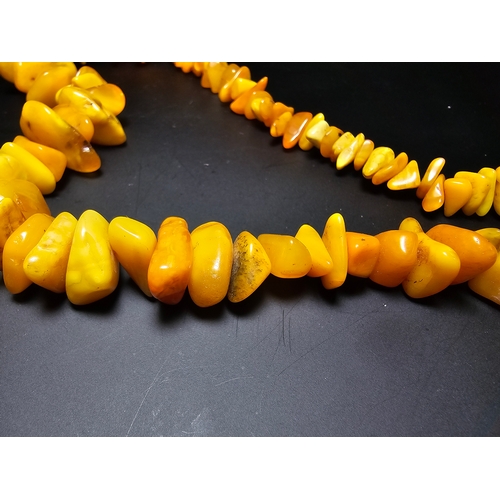 190 - A good quality vintage genuine butterscotch amber beaded necklace featuring polished shaped amber be... 