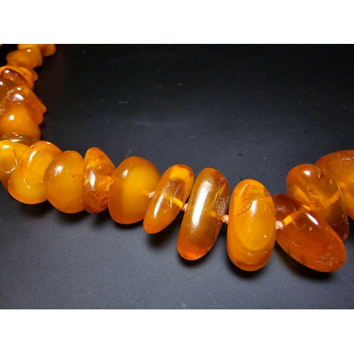 191 - A good quality vintage genuine egg yolk amber beaded necklace featuring polished shaped amber beads ... 