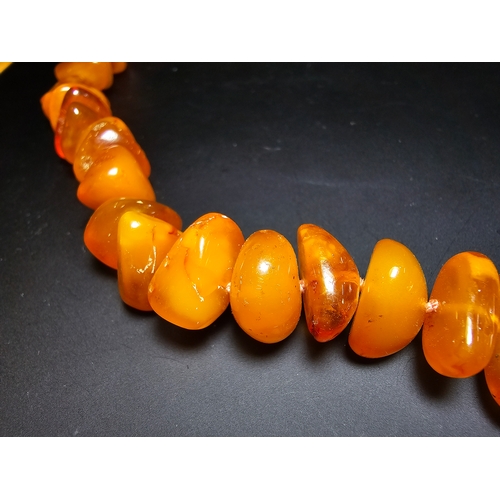 191 - A good quality vintage genuine egg yolk amber beaded necklace featuring polished shaped amber beads ... 