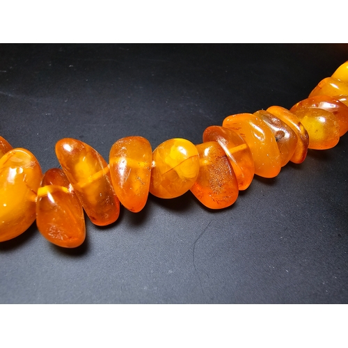 191 - A good quality vintage genuine egg yolk amber beaded necklace featuring polished shaped amber beads ... 