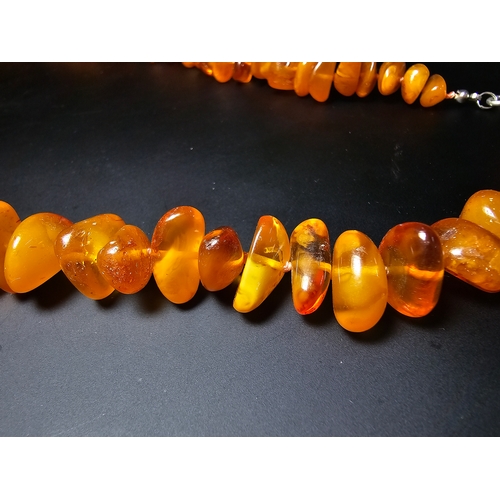 191 - A good quality vintage genuine egg yolk amber beaded necklace featuring polished shaped amber beads ... 