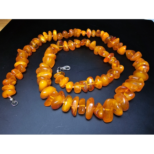 191 - A good quality vintage genuine egg yolk amber beaded necklace featuring polished shaped amber beads ... 