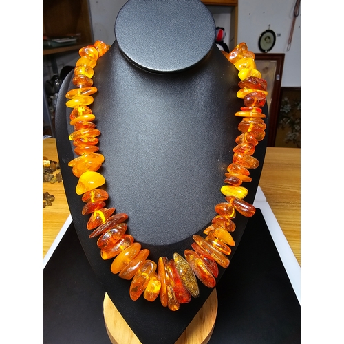 192 - A good quality vintage genuine baltic amber beaded necklace featuring polished shaped amber beads wi... 