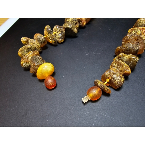 193 - A good quality vintage genuine butterscotch amber beaded necklace featuring natural amber beads are ... 