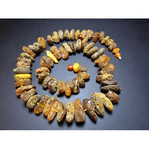 193 - A good quality vintage genuine butterscotch amber beaded necklace featuring natural amber beads are ... 