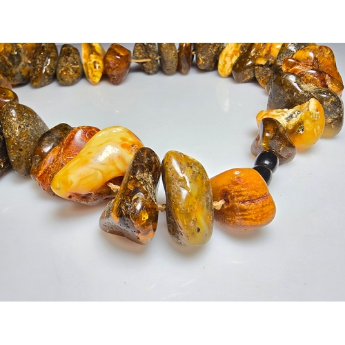 194 - A good vintage genuine amber large beaded necklace featuring loosely polished & shaped natural amber... 