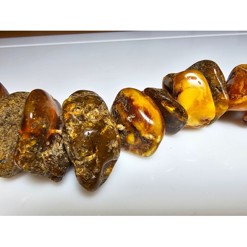 194 - A good vintage genuine amber large beaded necklace featuring loosely polished & shaped natural amber... 