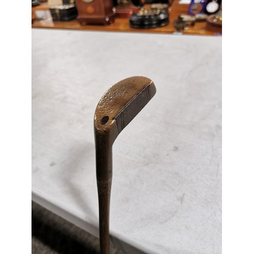 2 - An antique wooden hickory shafted golf putter made by H.E. Northwood, model medium lie, in good over... 