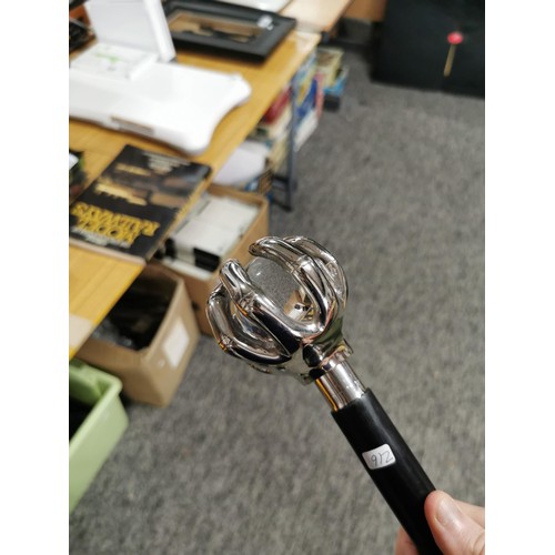 4 - A good quality walking stick in the form of a metal hand holding a glass ball, has a height of 95cm.