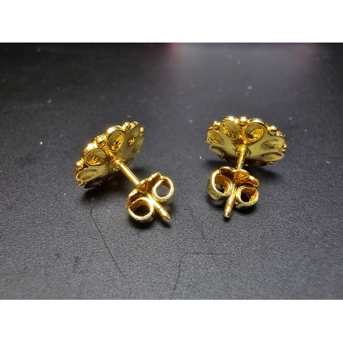 301 - Pair of good quality unused solid 18ct yellow gold stud earrings featuring an intricately worked flo... 