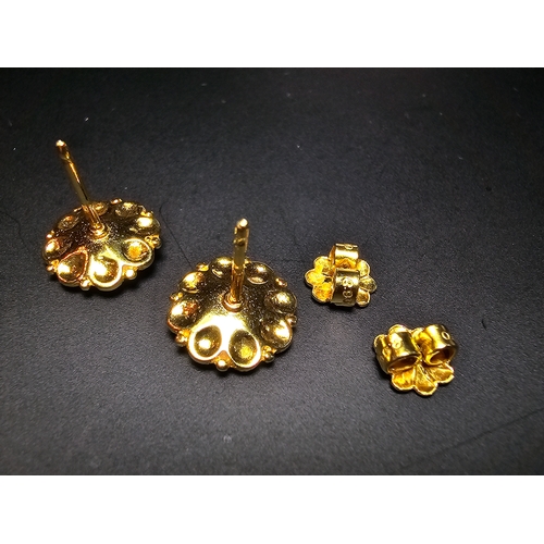 301 - Pair of good quality unused solid 18ct yellow gold stud earrings featuring an intricately worked flo... 