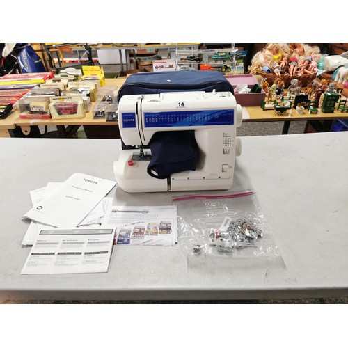 14 - A modern electronic sewing machine by Toyota in very good clean condition. Complete with pedal, orig... 