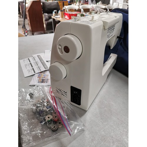 14 - A modern electronic sewing machine by Toyota in very good clean condition. Complete with pedal, orig... 