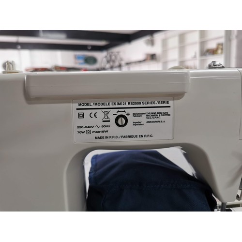 14 - A modern electronic sewing machine by Toyota in very good clean condition. Complete with pedal, orig... 