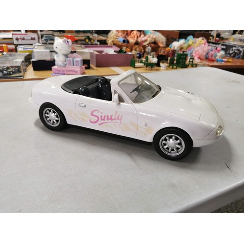 24 - A large selection of Sindy dolls along with a convertible 
Sindy car, measures 47cm in length.