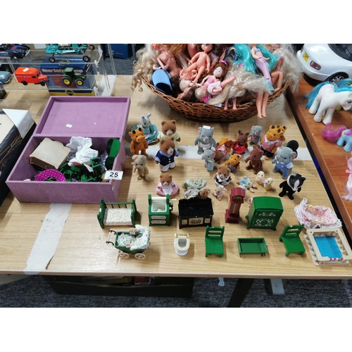 25 - A large collection of various Sylvanian families figures along with many furniture items housed in a... 