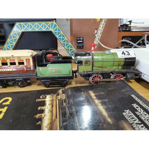 43 - A quantity of 0 gauge model railway items to include loco, rolling stock, bridge, etc.