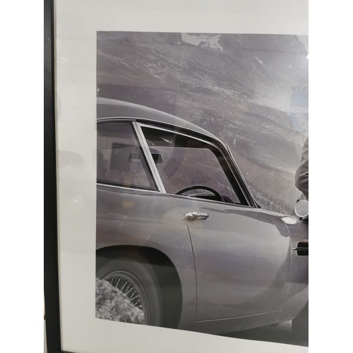 90 - A framed and glazed print of Sean Connery as James Bond 007 in the alps with an Aston Martin DB6, fr... 