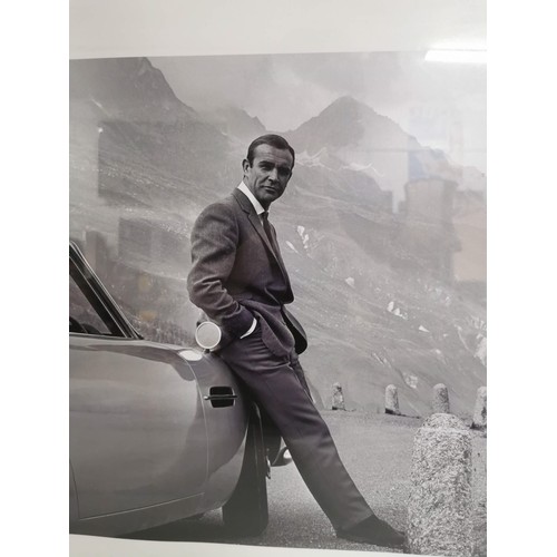 90 - A framed and glazed print of Sean Connery as James Bond 007 in the alps with an Aston Martin DB6, fr... 