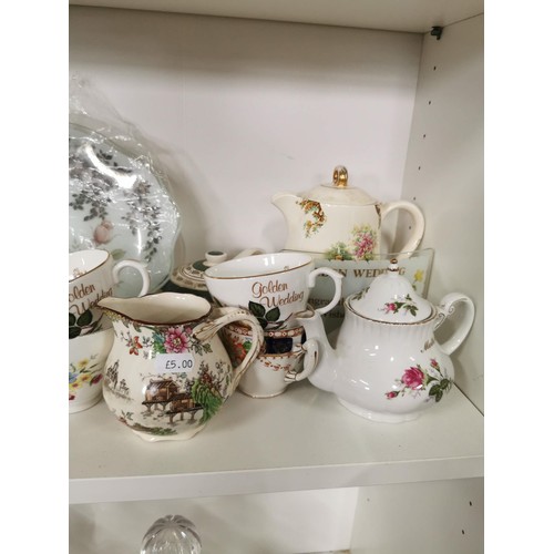 106 - Shelf full of collectable china mostly relating to wedding anniversary's inc Golden Wedding cups and... 