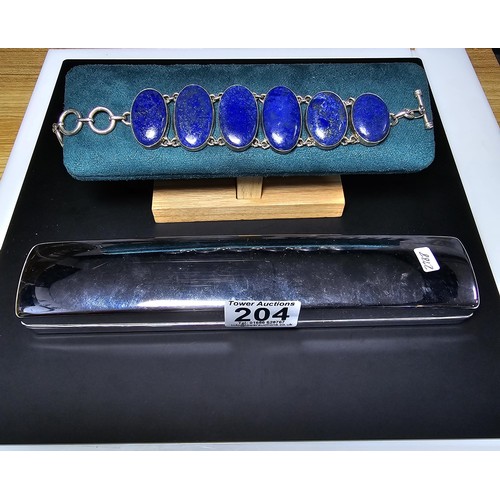 204 - A large 925 silver bracelet inset with 6 large oval lapis lazuli stones presenting vibrant blue natu... 