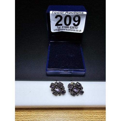 209 - A pair of good quality 925 silver stud earrings, both earrings are inset with faceted amethyst gemst... 