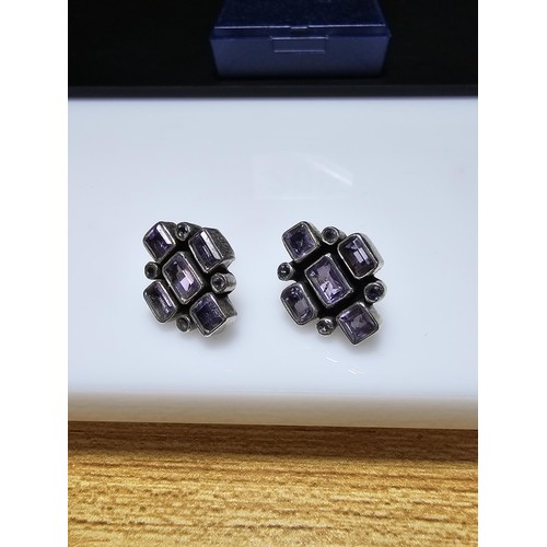 209 - A pair of good quality 925 silver stud earrings, both earrings are inset with faceted amethyst gemst... 