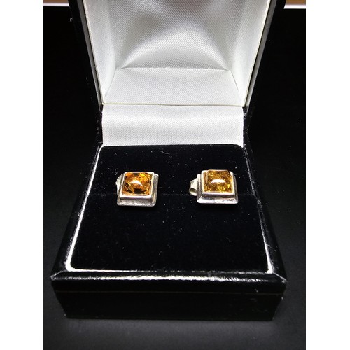 211 - A pair of pretty new and unused 925 silver stud earrings inset with natural Baltic amber, complete w... 