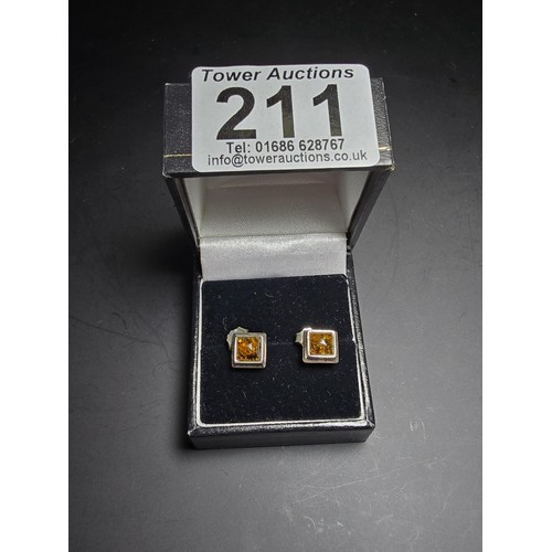 211 - A pair of pretty new and unused 925 silver stud earrings inset with natural Baltic amber, complete w... 