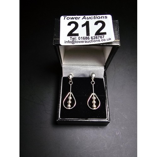 212 - A pair of unused 925 silver stud drop earrings featuring an unusual bead and hoop design, complete w... 