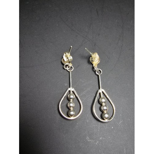 212 - A pair of unused 925 silver stud drop earrings featuring an unusual bead and hoop design, complete w... 