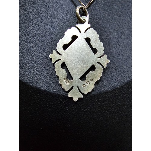 214 - A hallmarked silver vintage pendant featuring and ornate engraved design with a blank shield cartouc... 