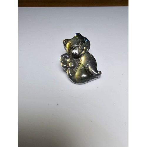 216 - A stunning labradorite carved cat figure presenting very good flashing colours throughout of yellows... 