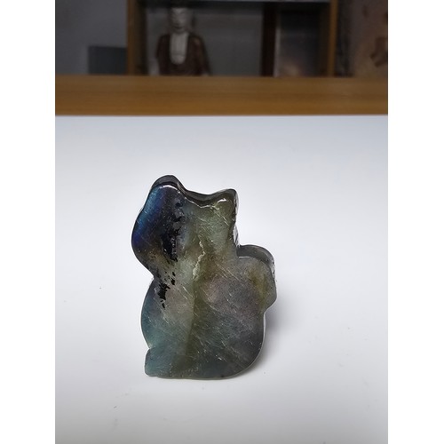 216 - A stunning labradorite carved cat figure presenting very good flashing colours throughout of yellows... 