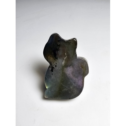 216 - A stunning labradorite carved cat figure presenting very good flashing colours throughout of yellows... 