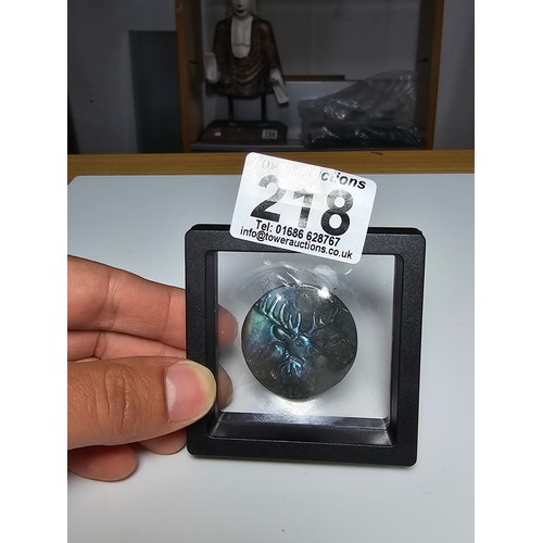 218 - A stunning carved labradorite hardstone carved disk with a stag scene presenting excellent natural f... 