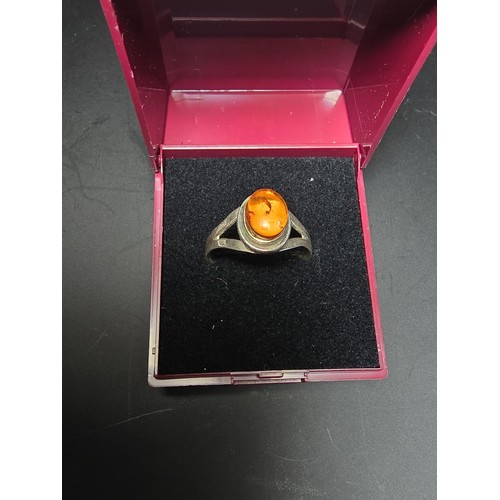 210 - An attractive 925 silver dress ring inset with a large natural Baltic amber cabochon stone. In excel... 