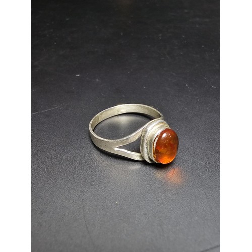 210 - An attractive 925 silver dress ring inset with a large natural Baltic amber cabochon stone. In excel... 