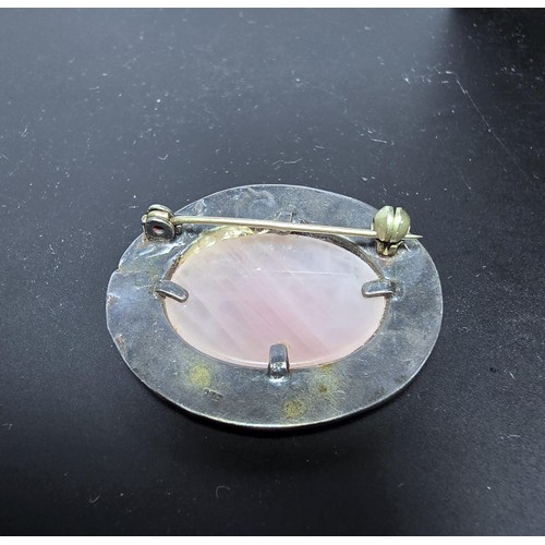 224 - An attractive vintage 925 silver brooch inset with a large oval rose quartz stone, the brooch featur... 