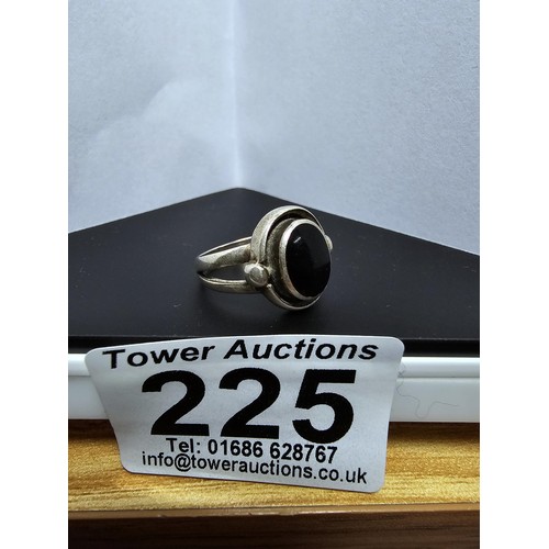 225 - A good vintage 925 silver ring with an unusual design inset with a large black onyx stone. Size K, i... 