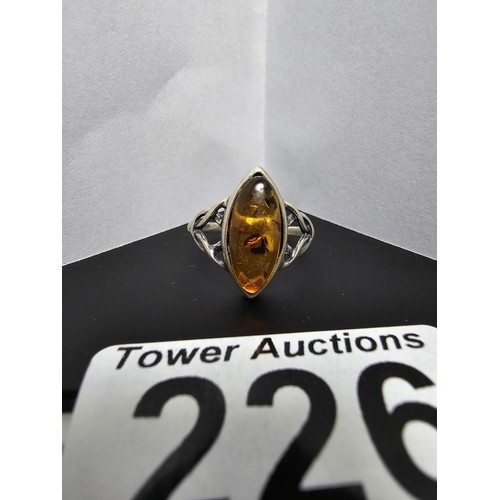 226 - A pretty 925 silver dress ring inset with a large natural Baltic amber stone, size O.5, in good clea... 