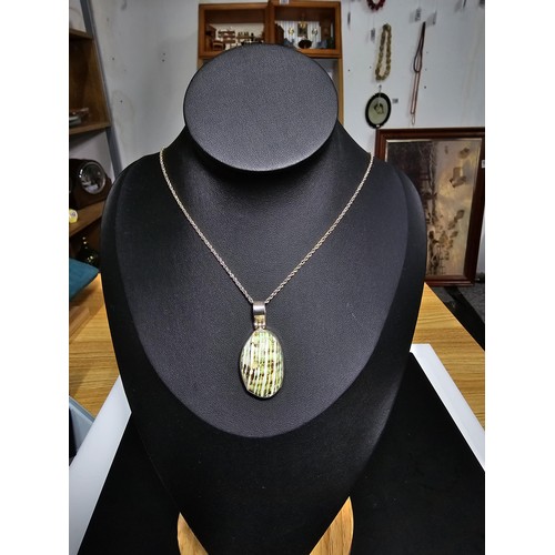 227 - A 925 silver large pendant inset with a colourful green natural glazed shell set on an 18