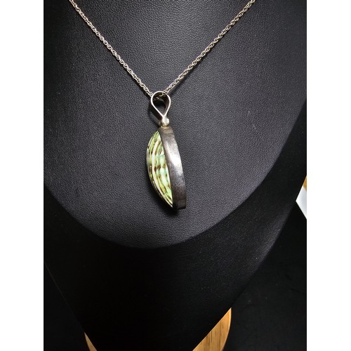 227 - A 925 silver large pendant inset with a colourful green natural glazed shell set on an 18