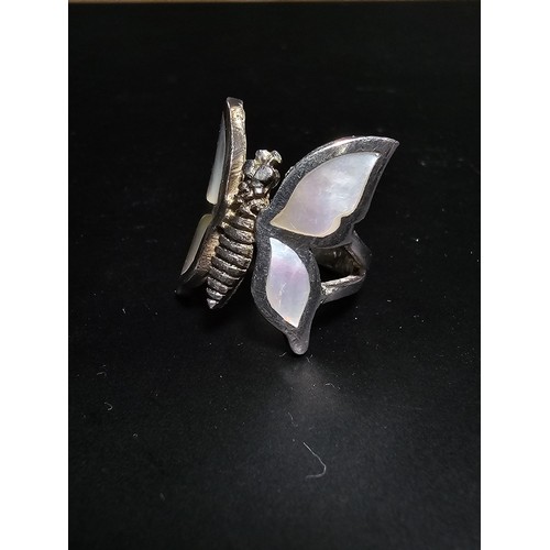 228 - A very pretty 925 sterling silver butterfly ring featuring a large butterfly design inset with mothe... 