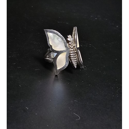 228 - A very pretty 925 sterling silver butterfly ring featuring a large butterfly design inset with mothe... 