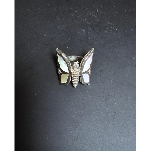 228 - A very pretty 925 sterling silver butterfly ring featuring a large butterfly design inset with mothe... 