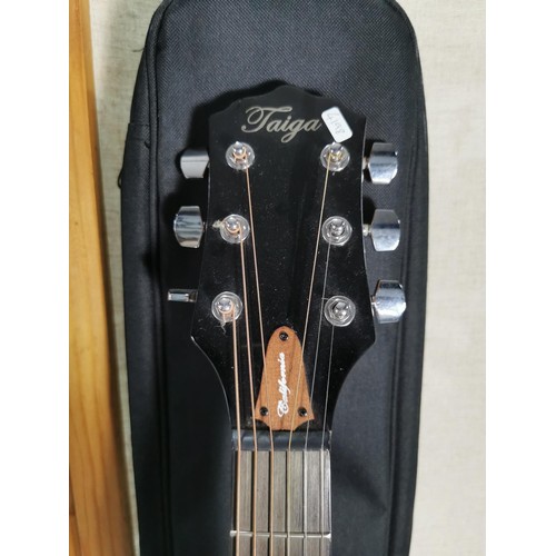 133 - A Taiga California series electro acoustic guitar, with gigbag in good order.